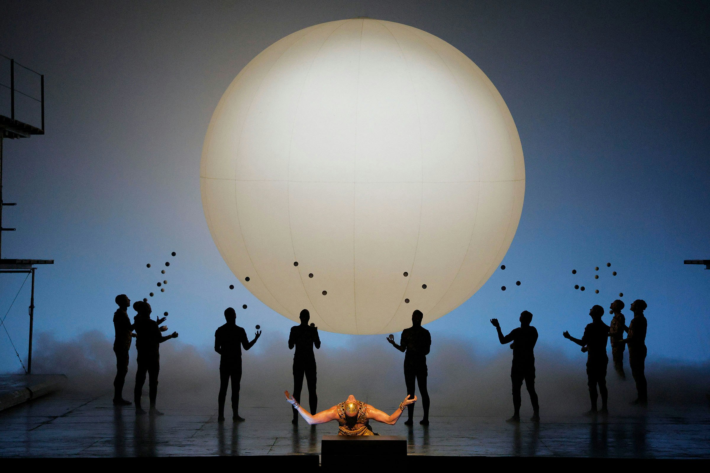 Akhnaten Act 2: The Narrator (Amenhotep, played by Zachary James) with jugglers (LA Opera; photo by Cory Weaver)