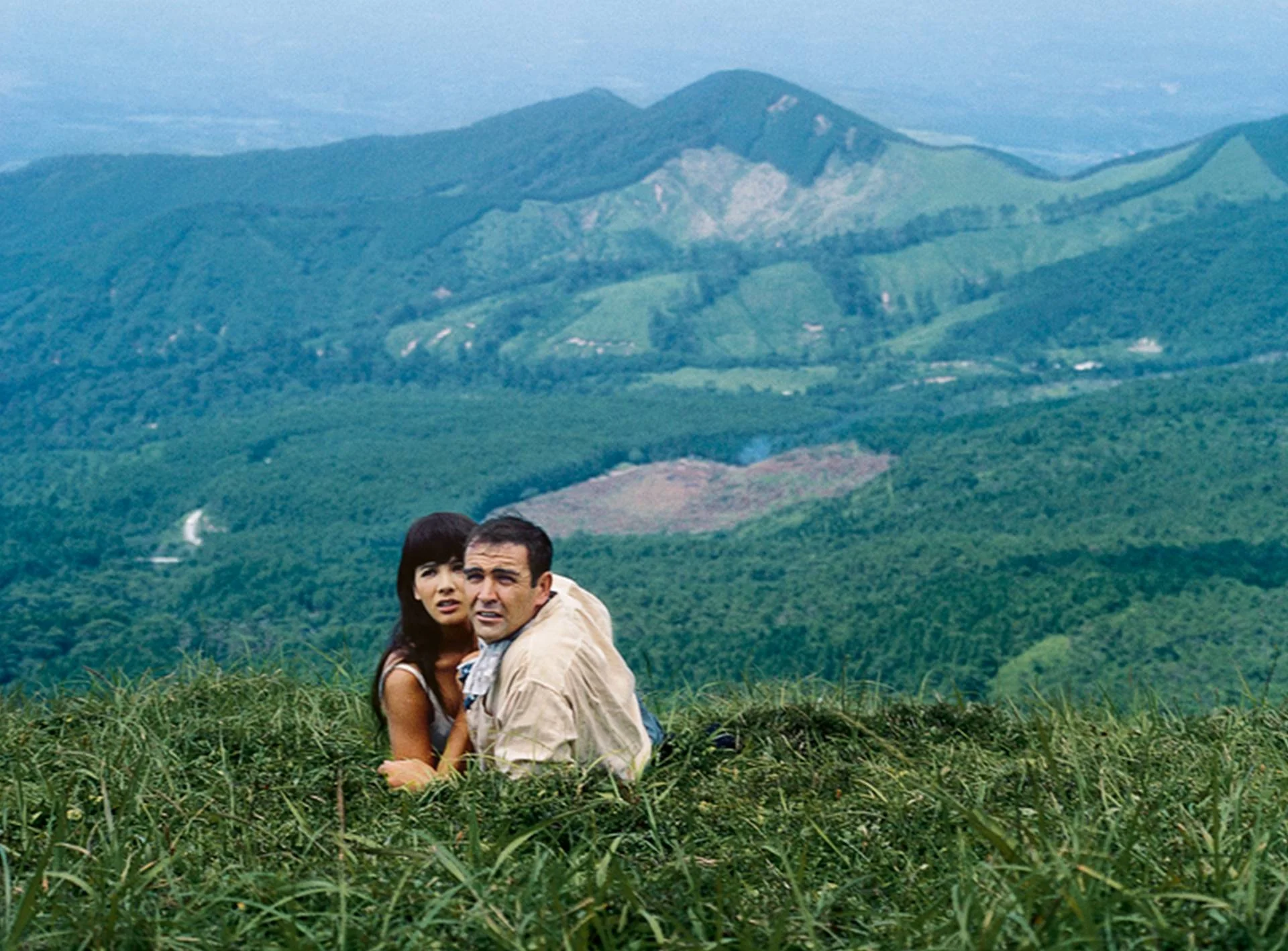 Aki (Akiko Wakabayashi) and Bond on the slopes of Blofeld's secret volcano base - You Only Live Twice