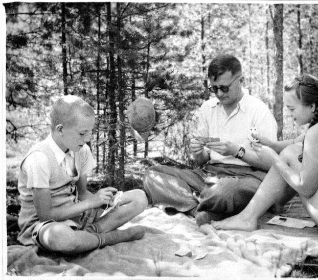 The composer playing cards with his children in the 1940s. Son Maxim, future conductor, is on the left.