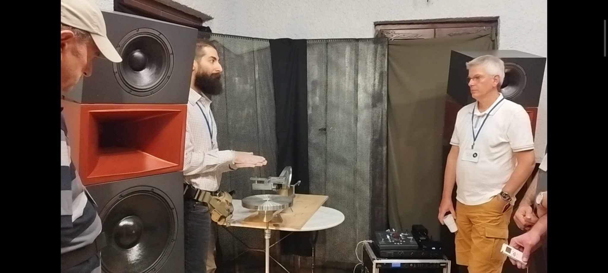 J. I. Agnew (Agnew Analog) demonstrating the Agnew Analog Reference Instrument Type 612 disk mastering lathe. To his left, on the other side of the Spine Audio monitor loudspeaker is Yannis Ioannidis (Polygram) and to his right is Miles Showell (freelance mastering engineer at Abbey Road Studios).