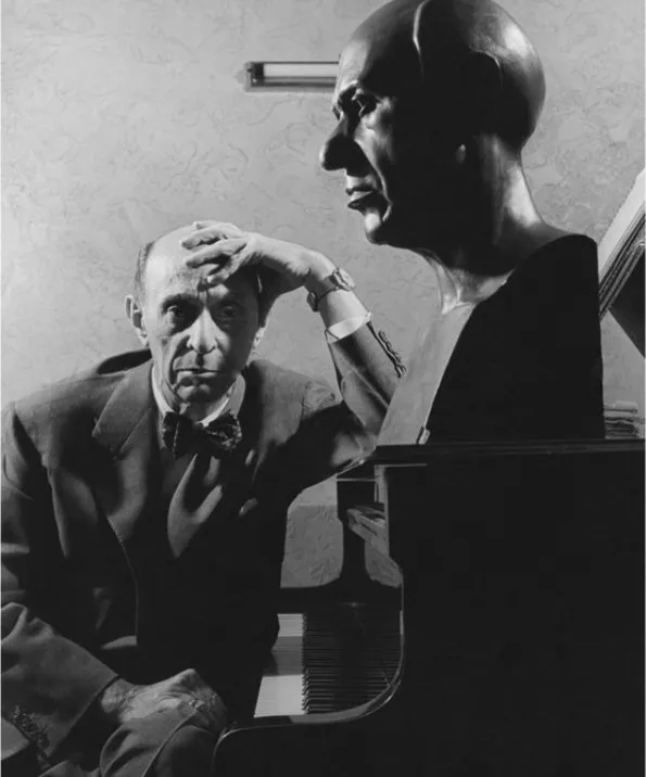Arnold Schoenberg in 1937 in a perfect "meta" moment, with a bust of himself by Rudy Zack